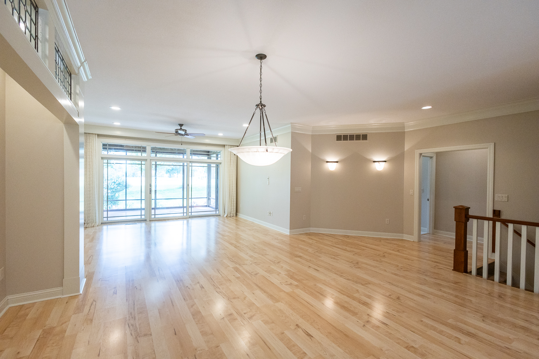 Living room with crown molding and golf course view