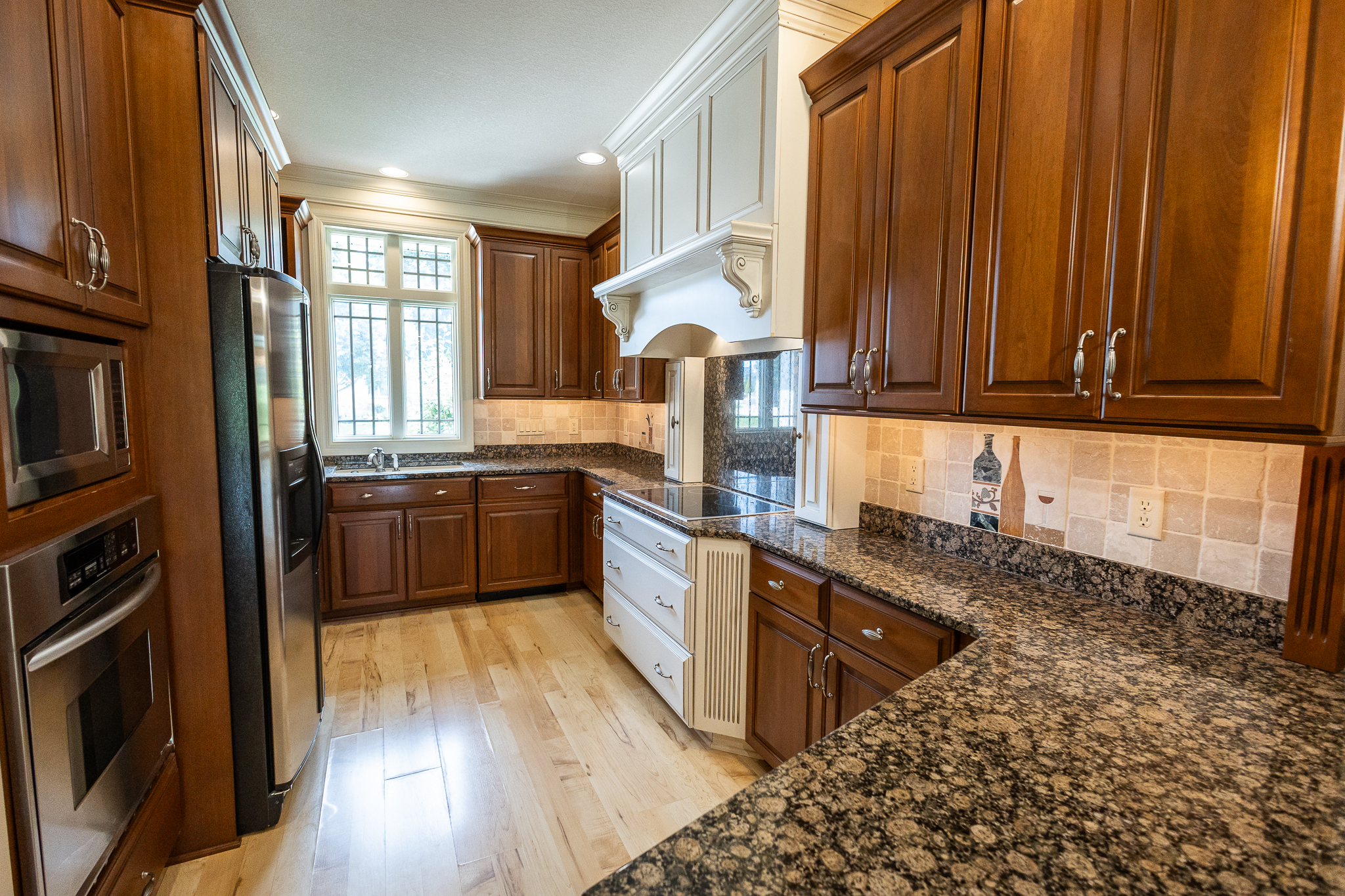 Kitchen with Woodharbor cherry cabinets and granite counters