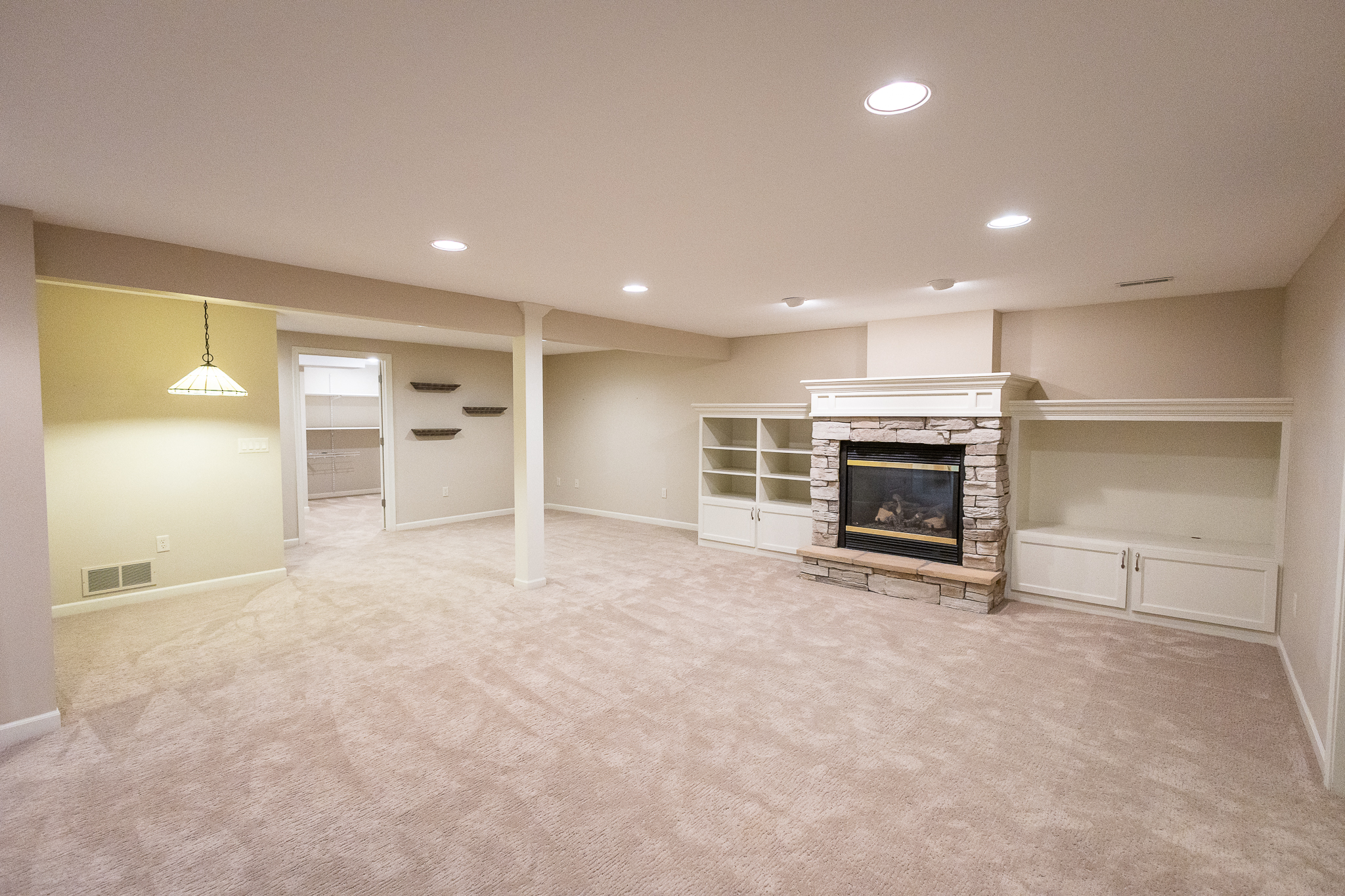 Finished lower level with gas fireplace and built-in